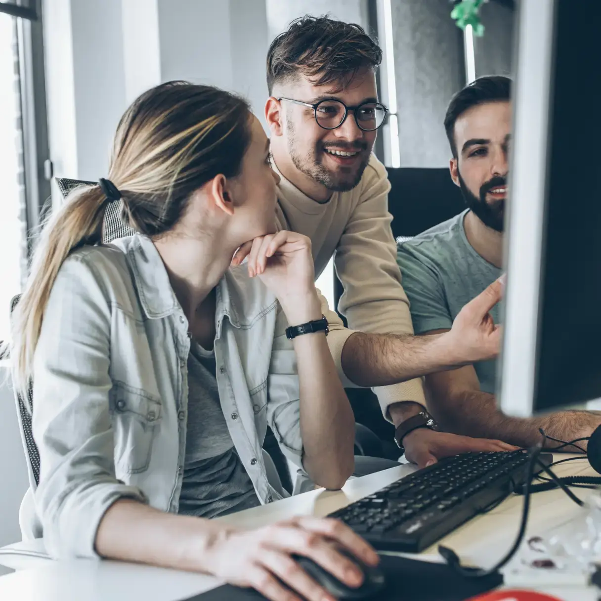 A group of young people looking at a computer screen