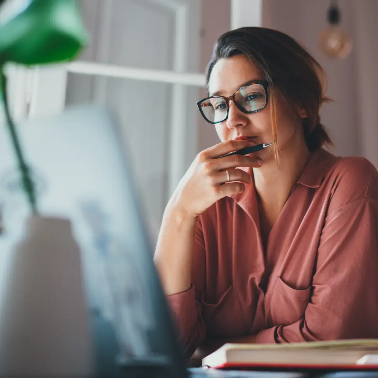 A young woman looking at her laptop
